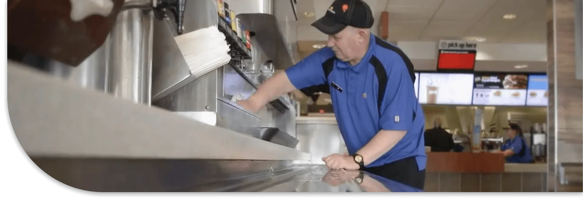 Employee cleaning soda fountain at restaurant