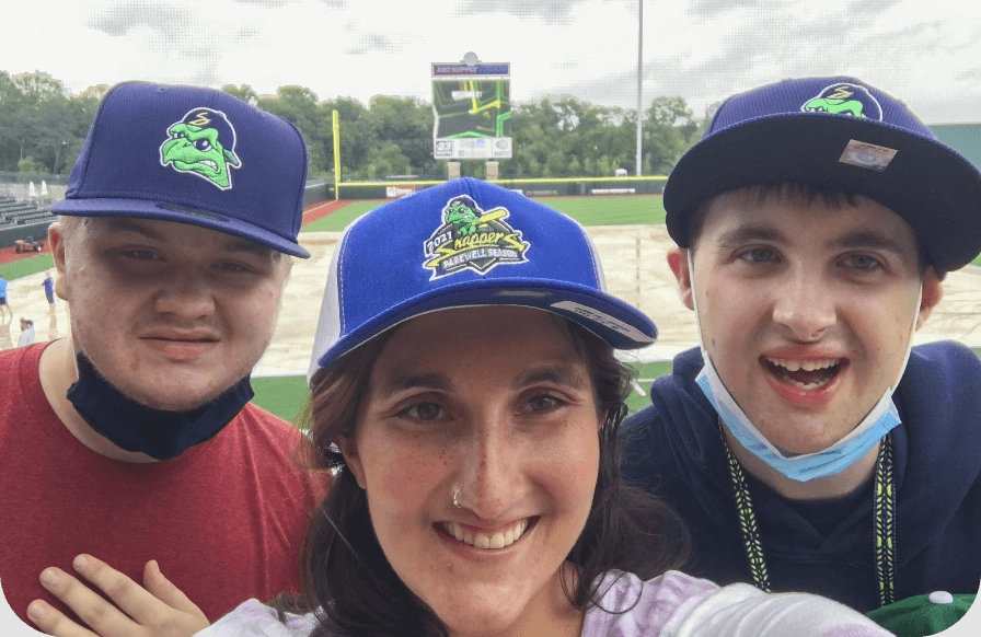 Friends smiling at a baseball game