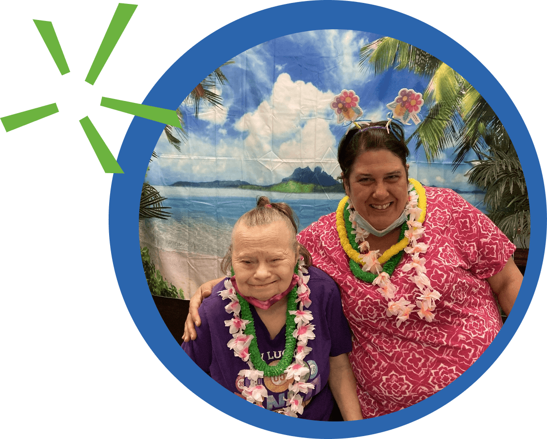 Two friends smiling with hawaiian shirts on